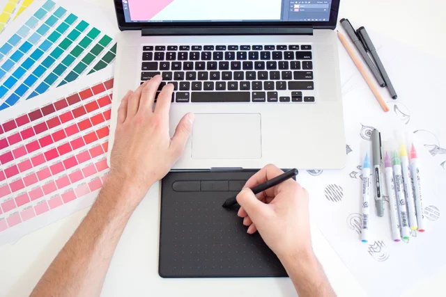 designer hands at computer with color palettes