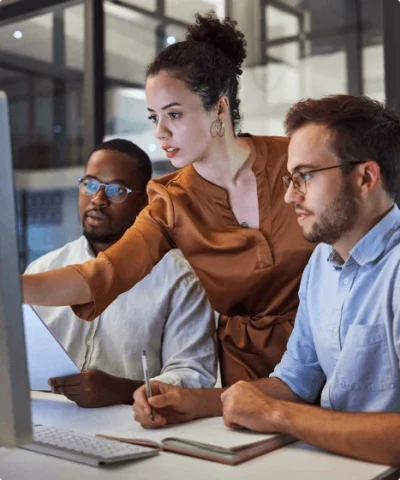 three developers looking at a computer screen